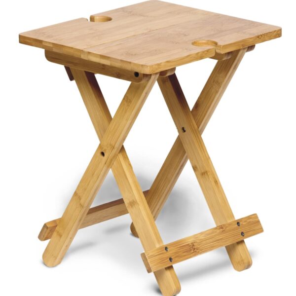 A small, square wooden folding table with a natural finish. The table has crossed legs for stability and rounded cutouts on the top edges.