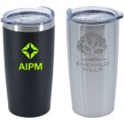 Two insulated travel tumblers with clear lids. The black tumbler has a green logo and the text AIPM. The silver tumbler features a tree design and EMERALD Hills in gray.
