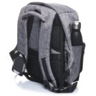 Gray backpack with padded straps and multiple pockets, holding a stainless steel water bottle in a side pocket. A smartphone with earphones plugged in is attached to one of the shoulder straps.