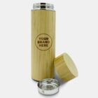 A bamboo insulated travel mug with the lid removed, revealing a strainer insert. The mug features a customizable logo area labeled Your Brand Here. The background is a plain white surface.