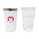 A white tumbler with a silver lid featuring a red logo and the word MUSICMEDIA next to a clear plastic cup filled with water.