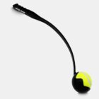 A black dog ball launcher with Royal Canin written on the handle. It is holding a neon yellow and black tennis ball in a curved cradle at the end. The launcher is against a plain white background.