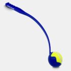 A blue dog ball launcher with a curved handle holds a yellow tennis ball in its cradle. The handle has Royal Canin printed on it. The background is plain white.