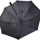 A black umbrella is open, viewed from below, showing the metal ribs and central pole. The umbrella is against a plain white background.