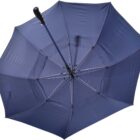 A blue umbrella with a black handle is open, viewed from below. The fabric is taut, and metal ribs radiate outward, creating a circular pattern. The umbrella is set against a plain white background.