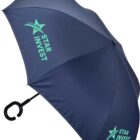 A large, open navy blue umbrella with a black C-shaped handle. It features the words Star Invest and a star logo in light blue on two opposite sections of the umbrella.
