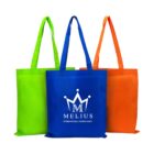 Three reusable tote bags are displayed side by side. The bags are green, blue, and orange. The blue bag features the logo and text Melius International Consultancy in white. The design includes a stylized crown and letter M.