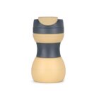 A reusable travel mug with a sleek design, featuring a dark gray lid and midsection, and a light beige base and top section, suitable for hot or cold beverages.