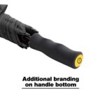 A black umbrella with a curved, ergonomic handle. The bottom of the handle features a round yellow emblem with a red logo. Below the umbrella, text reads: Additional branding on handle bottom.