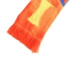 Close-up of an orange scarf with fringed ends featuring abstract yellow and blue patterns.