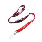 A multicolored lanyard with a metal clip. The design features a pattern of red, blue, pink, and white dots and shapes, with a section of solid red displaying the text WATER and a water drop icon.