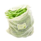 A white mesh bag filled with fresh green beans, labeled with a tag that reads credo bags organics. The bag is partially open at the top, showing the beans inside. The background is plain white.