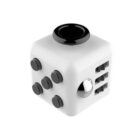 A white fidget cube with various features on its sides, including five black buttons on one face, a silver ball and gears on another, and a circular black disc on top.