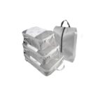 A set of four gray packing cubes: three stacked horizontally with mesh tops and handles, and one standing vertically with a zipper and handle, designed for organizing luggage efficiently.
