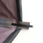 Close-up of a black pole inserted into fabric sleeves, forming a corner structure.
