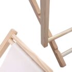 Close-up of light wood furniture components connected at angles. Visible are smooth, rounded edges and joints, with part of a white upholstered surface on the left. The design appears minimalistic and modern.