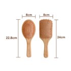Two wooden hairbrushes with brown bristles are shown. The left brush is oval-shaped and measures 22.8 cm by 8 cm. The right brush is rectangular and measures 24 cm by 8 cm.