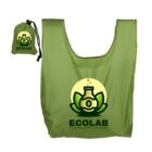 A green reusable shopping bag featuring a logo of a beaker with leaves and bubbles, labeled ECOLAB HERBAL CONCOCTIONS. The bag is shown folded in a small matching pouch with the same logo.