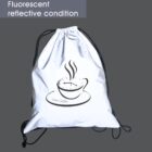 A drawstring bag with a reflective surface features a steaming cup design with clock numerals around the rim. The text Time Coffee appears below. The image demonstrates its fluorescent reflective quality against a dark background.