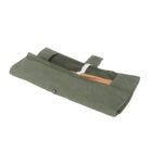 A green fabric pouch with a button closure, partially open to reveal a wooden item inside. The pouch is laid flat against a white background.