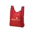 Red reusable shopping bag with bioisland and a small leaf graphic printed in white.