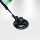 A close-up of a black suction cup mount attached to a pole. Part of a green and white flag or banner is visible at the top left. The background is a smooth, light gradient.