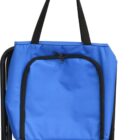 A person wearing a wristwatch holds a blue bag with black handles and a front zipper pocket. The bag is attached to a foldable black metal camping stool.