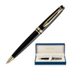 A sleek black and gold ballpoint pen with gold accents is shown. Below, the pen is displayed in an open blue and white box on a white background.