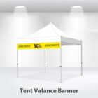 A white tent with a yellow banner displaying DISCOUNT 50% OFF in bold letters. The tent is set up indoors with spotlights illuminating it from above. Text below the tent reads Tent Valance Banner.