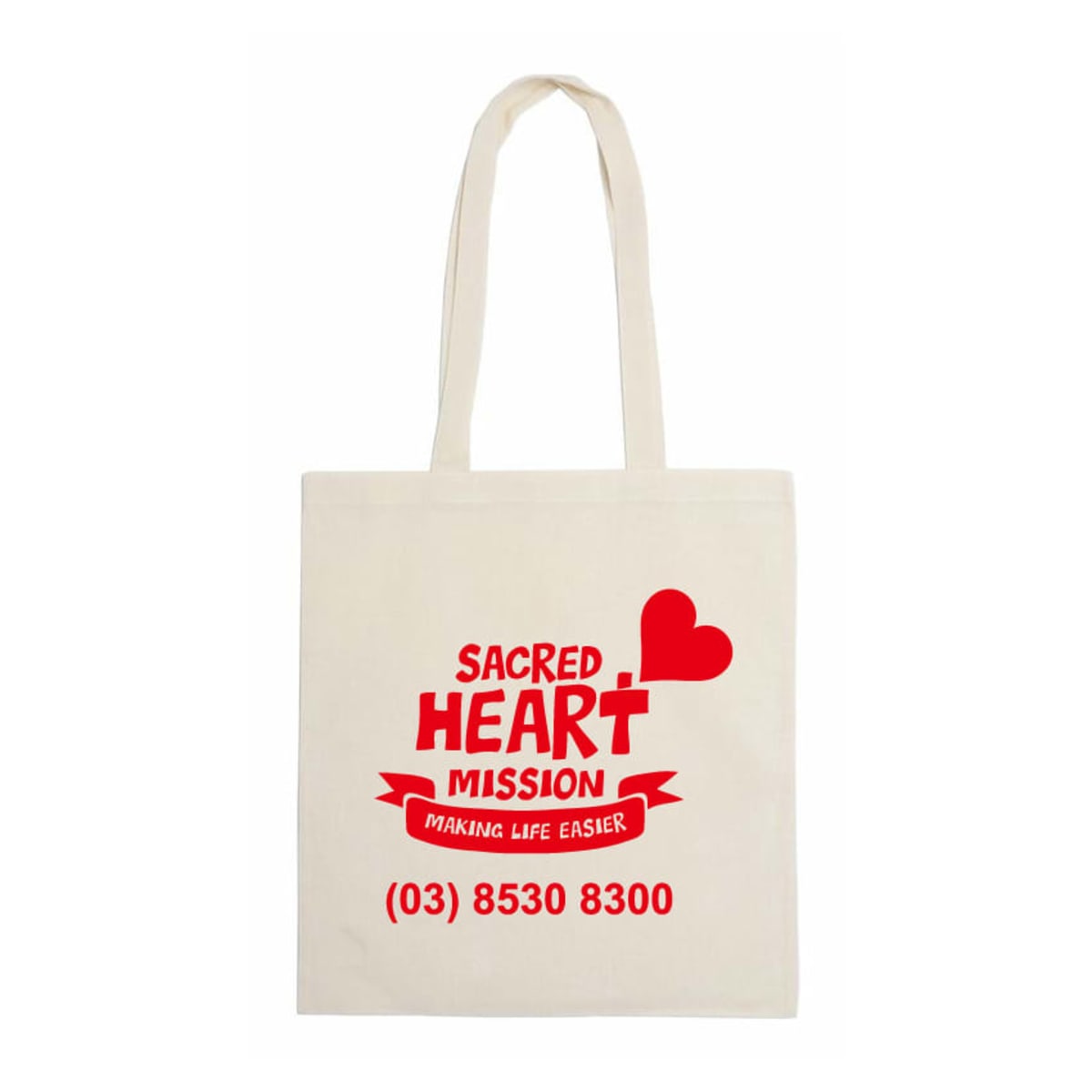 Canvas tote bag with red text and graphics. Reads: Sacred Heart Mission with a heart and banner stating Making Life Easier. Includes a phone number: (03) 8530 8300. Bags handles are visible above.
