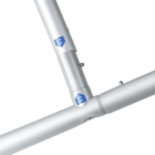 Close-up view of a silver metal frame with two attached tubes, featuring blue and white logo stickers on both tubes.
