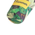 A close-up of a cylindrical object with a colorful tropical leaf pattern. The design includes green, yellow, and black shades. Theres a yellow label with the word Summer printed in bold letters.