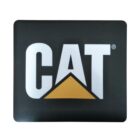 A black square mouse pad featuring the word CAT in bold white letters. The letter A is stylized with a yellow triangle beneath it, resembling a mountain peak.