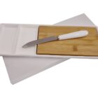 A white rectangular tray with a bamboo cutting board and a knife with a white handle placed on top. The tray has two sections for organization.
