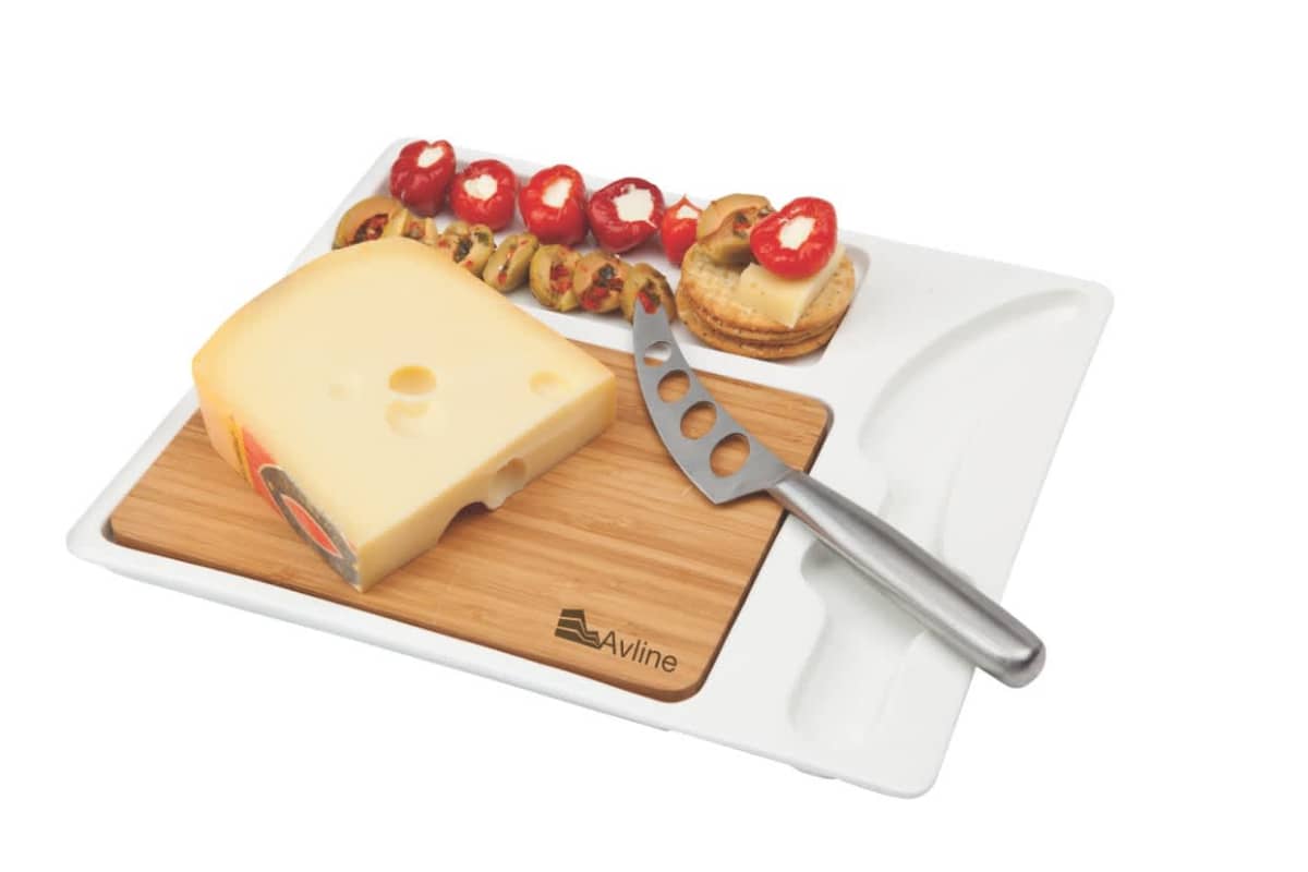 A cheese board with a knife, a block of cheese, and various appetizers including crackers, sliced cheese, and stuffed tomatoes arranged neatly on a wooden plate.