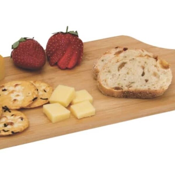 A wooden serving board with a slice of cheese, two strawberries, four crackers topped with herbs, a few cheese cubes, and a slice of bread.