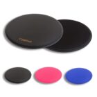 Four round exercise sliding discs shown. The front disc is black with the word COMPANY, and a similar black disc is partially behind it. Below are three discs in black, pink, and blue. All discs have a glossy finish.