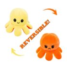 Two plush octopus toys: the top one is yellow with a happy face, and the bottom one is orange with a sad face. Text in the center reads REVERSIBLE! with arrows indicating the toy can be flipped.