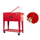 Red metal cooler on wheels with a hinged lid. The cooler features a built-in bottle opener on the front right corner. A round, inset image highlights a bottle cap being removed using the opener.