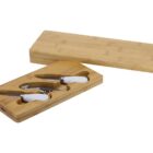 A bamboo cheese knife set with three knives featuring white handles, neatly placed in a carved wooden tray. The lid of the tray is shown slightly ajar, displaying the knives inside.
