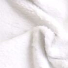 Close-up image of soft, white fur fabric with a slightly wavy texture. The focus is on the fluffy surface, highlighting its plush and cozy appearance, creating a sense of warmth and comfort.