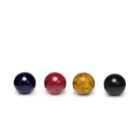 Four glossy spheres arranged in a row on a white background. From left to right, the spheres are dark blue, red, yellow, and black.