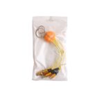 A packaged keychain featuring a round orange pumpkin with a carved face. It has multiple yellow cable connectors attached, with different types for charging.