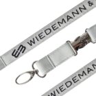 A gray lanyard with the text WIEDEMANN & printed on it. It features a metal clip and keyring attachment.
