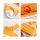 Four close-up images showing details of yellow socks with white stripes. Top left: toe area with white tip. Top right: logo with text. Bottom left: ankle cuff. Bottom right: person holding sock to show stretch.