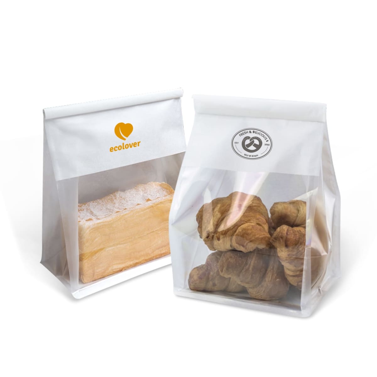 Two transparent bags. The left bag holds a loaf of bread with the ecolover logo in orange. The right bag contains croissants and displays a circular recycling symbol. Both bags have white paper tops.
