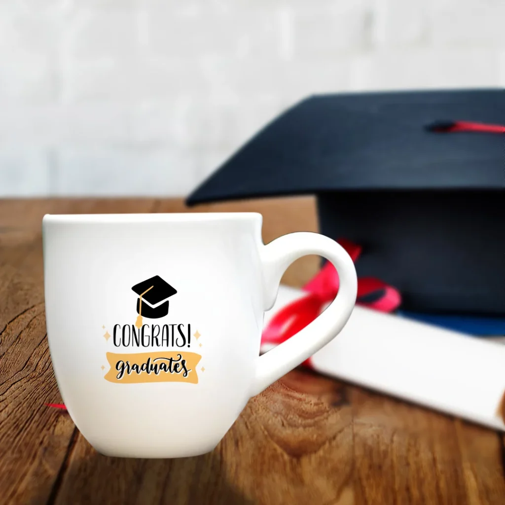 white mug with white roller paper and graduation cap