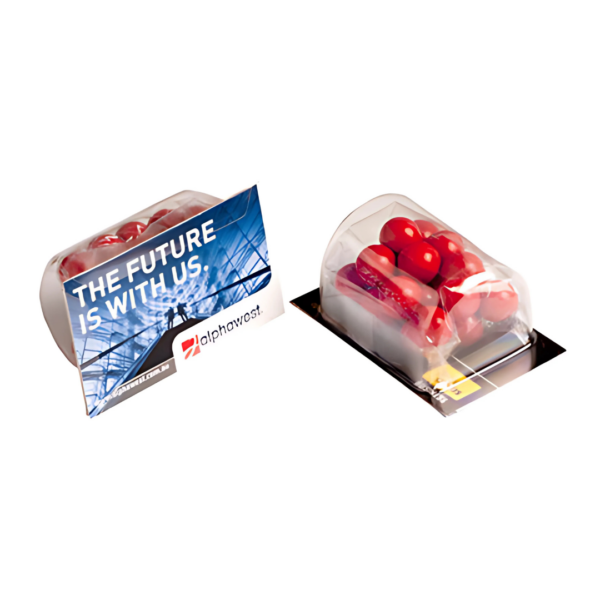 Two packaged sets of red pills in clear containers are shown. One package is labeled THE FUTURE IS WITH US with a stylish Alphavast logo, resembling the “Business Cards With Jaffas. The background showcases a futuristic structure.