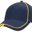 A dark blue baseball cap with yellow piping along the seams and brim. The cap features a curved visor and a structured crown.