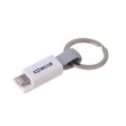A compact USB flash drive with a white and gray design, attached to a metal keyring. The drive features a lightning connector and branding text on its body.